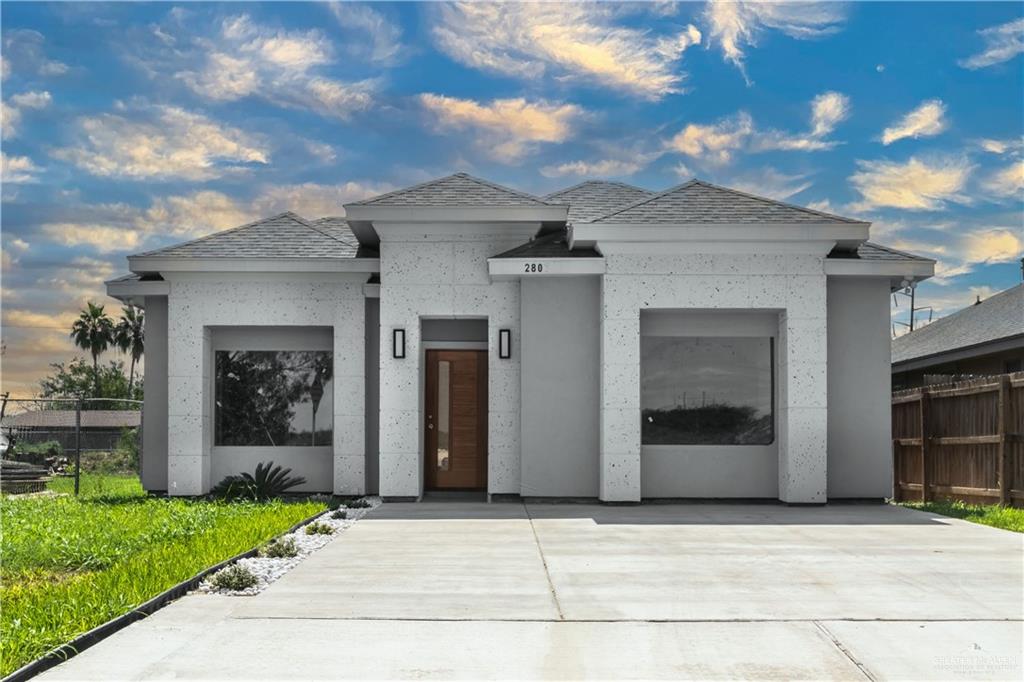 a front view of a house with a garden