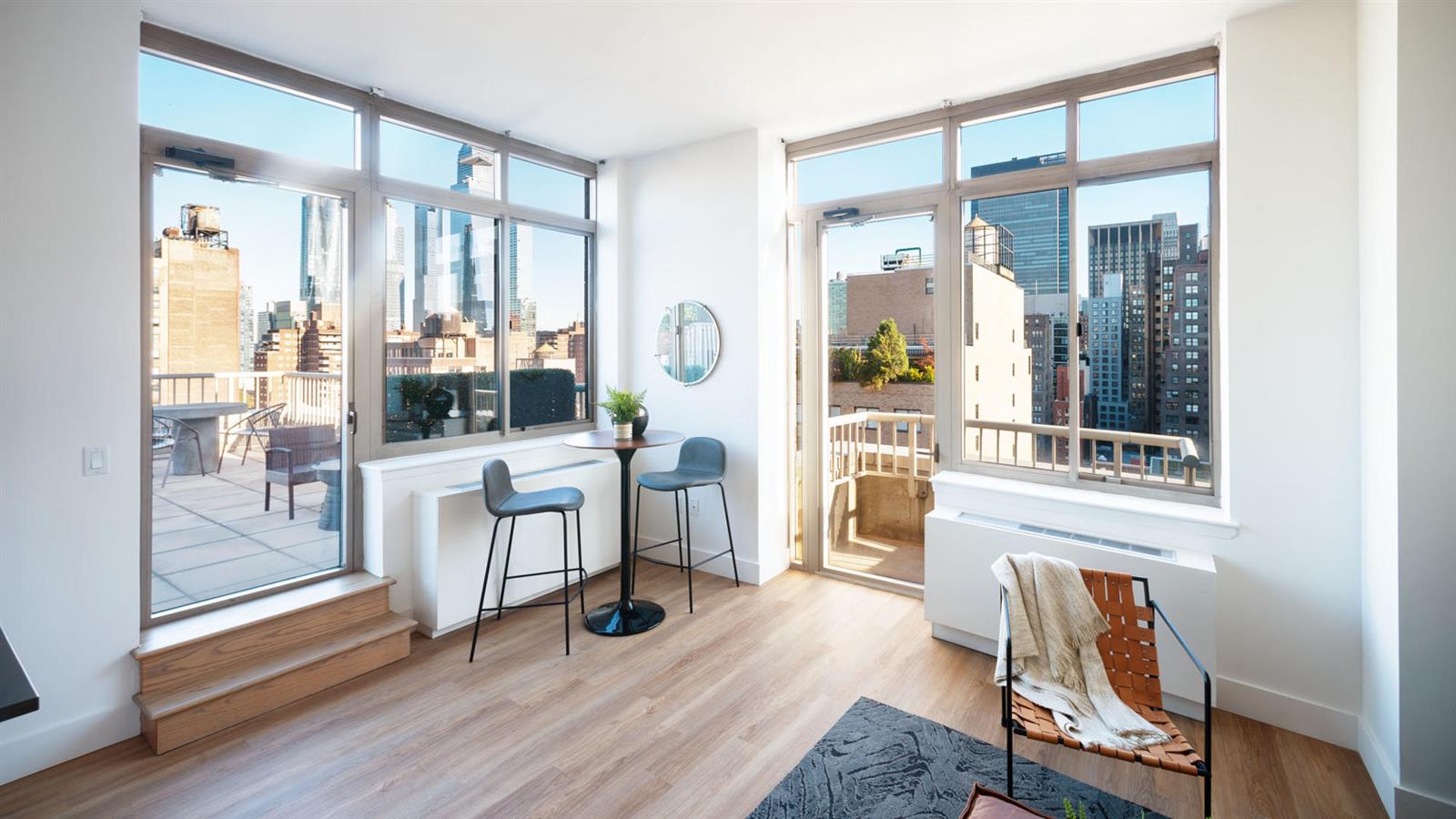 a living room with furniture a flat screen tv and a floor to ceiling window