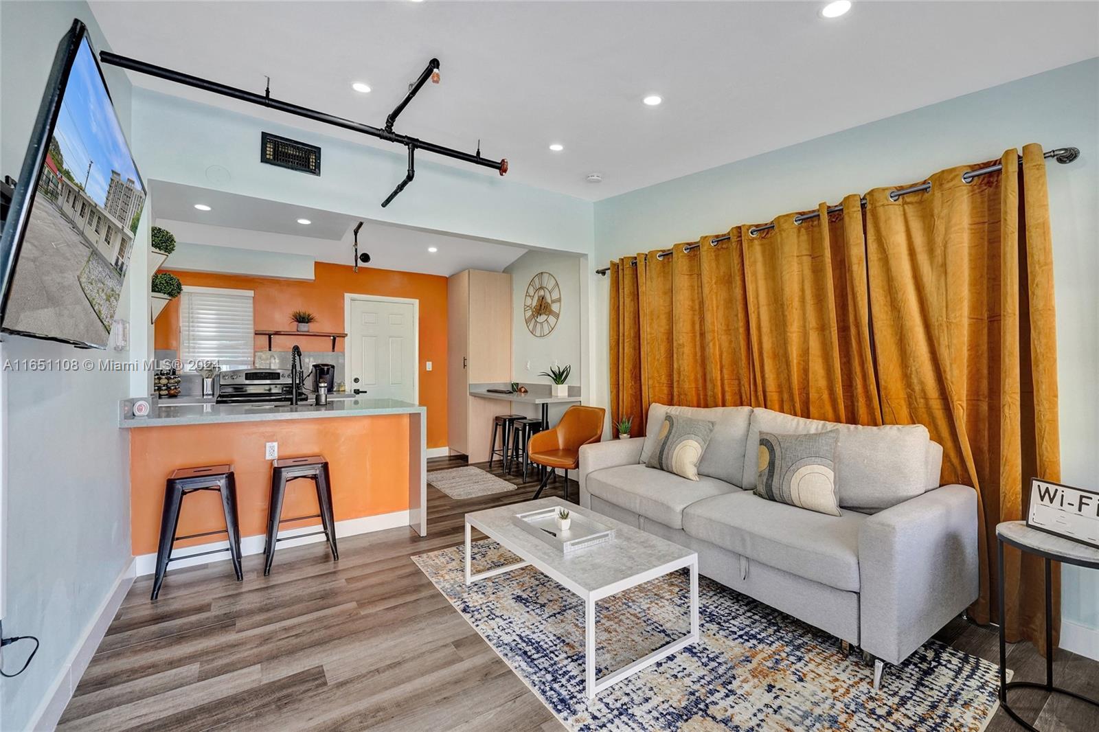 a living room with furniture a rug and a chandelier