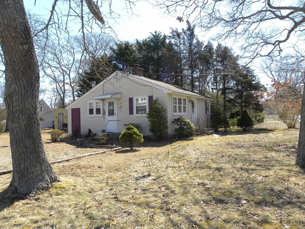 a front view of a house with a yard covered in snow