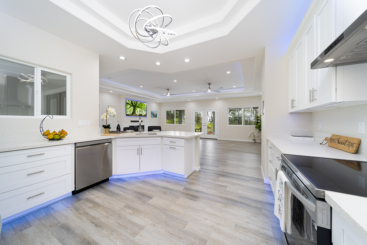 a kitchen with a sink stainless steel appliances cabinets and a counter top space