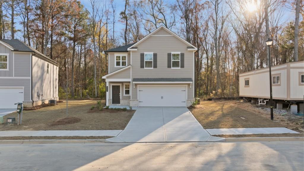 a front view of a house with a yard and garage