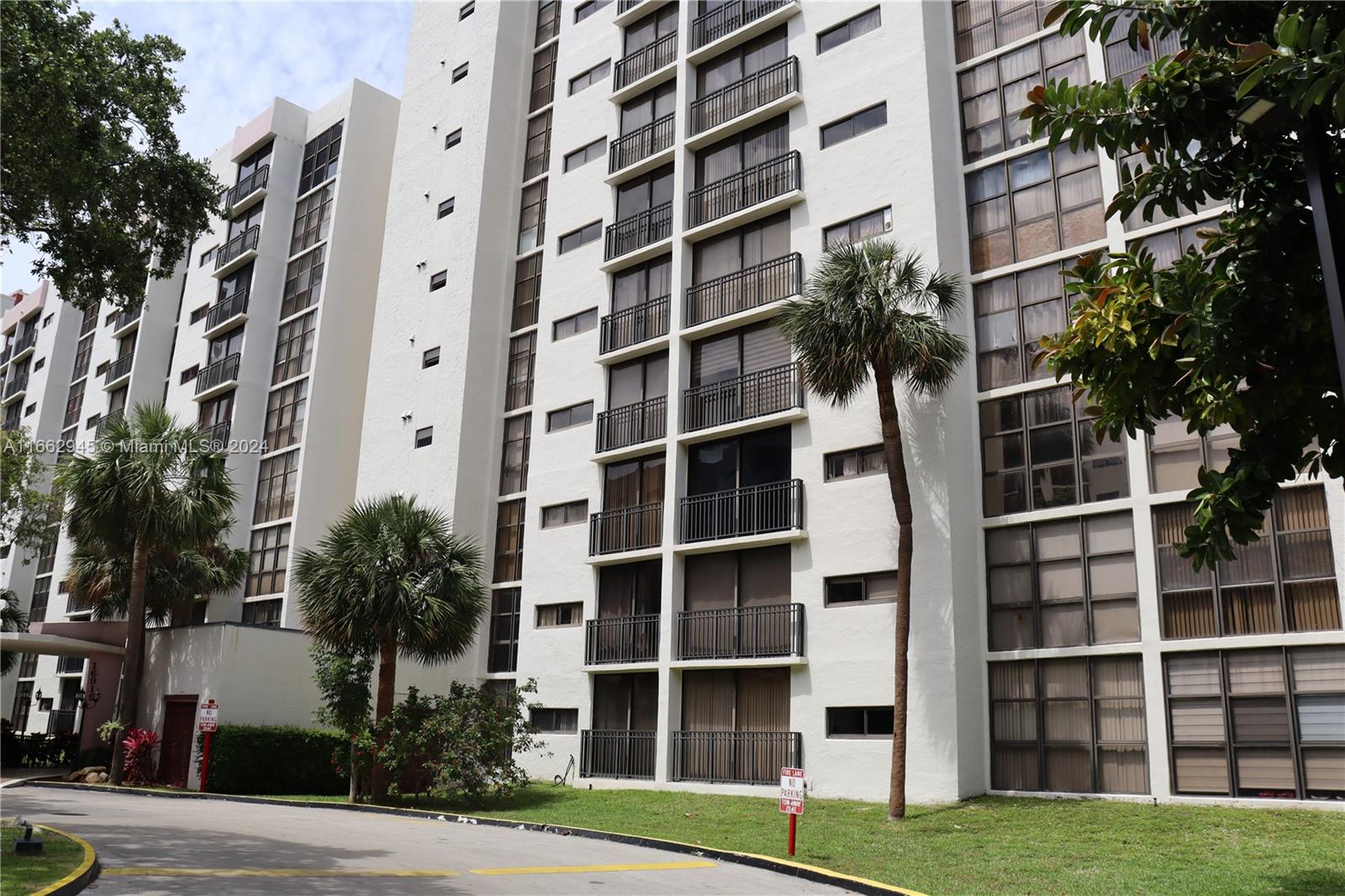 a view of tall buildings with yard in front of it