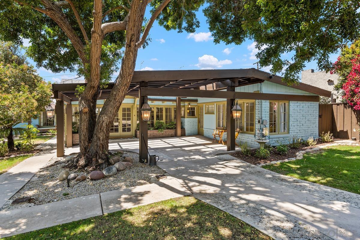 a view of a house with backyard porch and sitting area