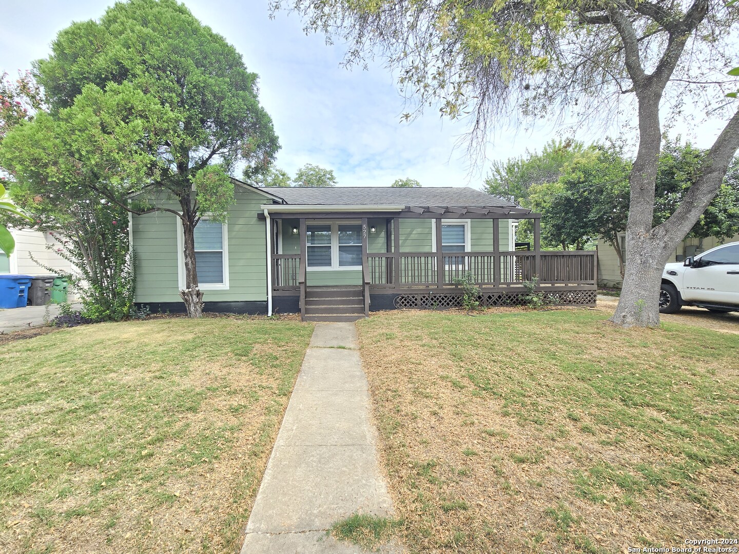 a front view of a house with a garden