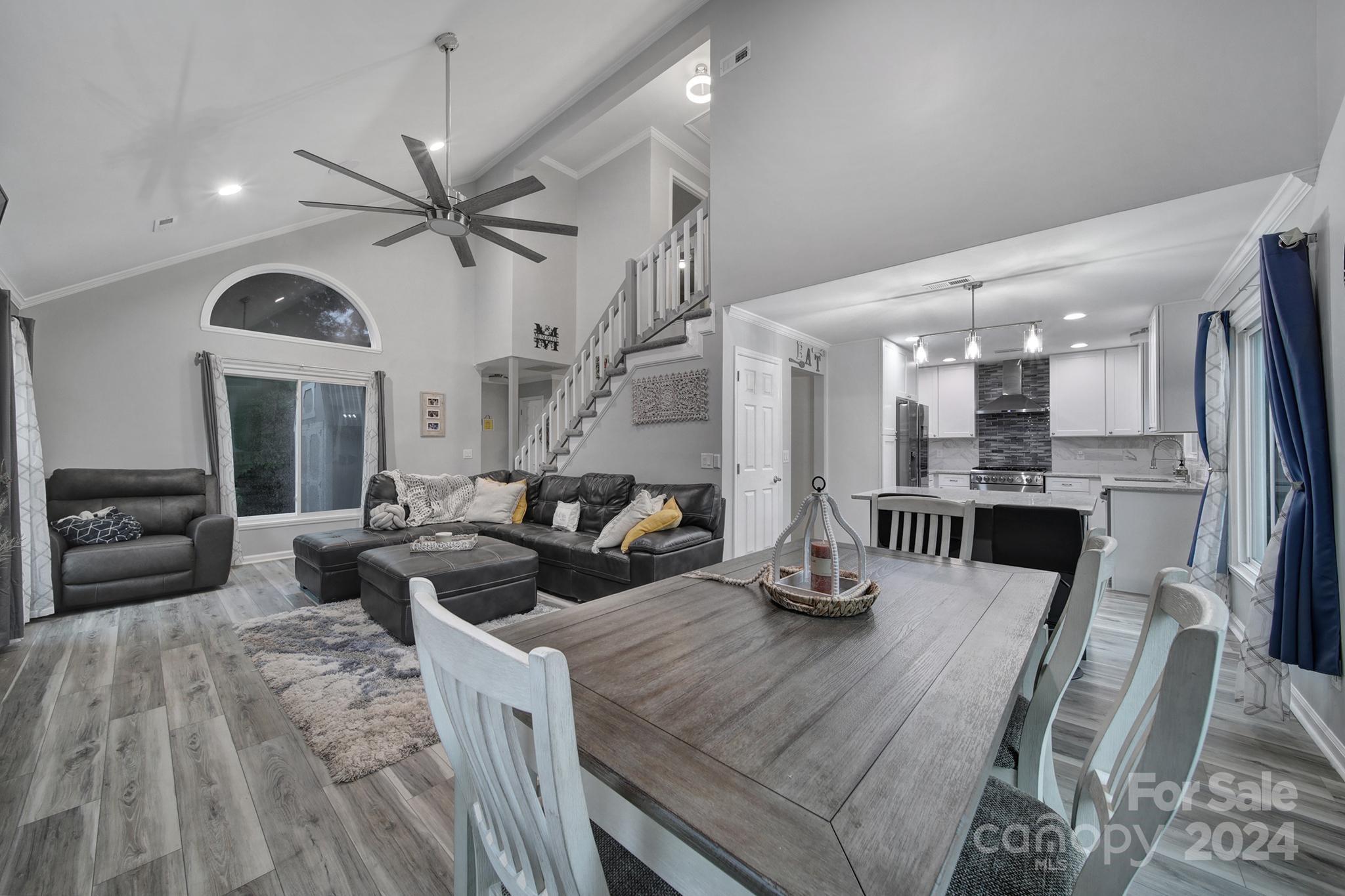 a dining room with furniture and a view of kitchen