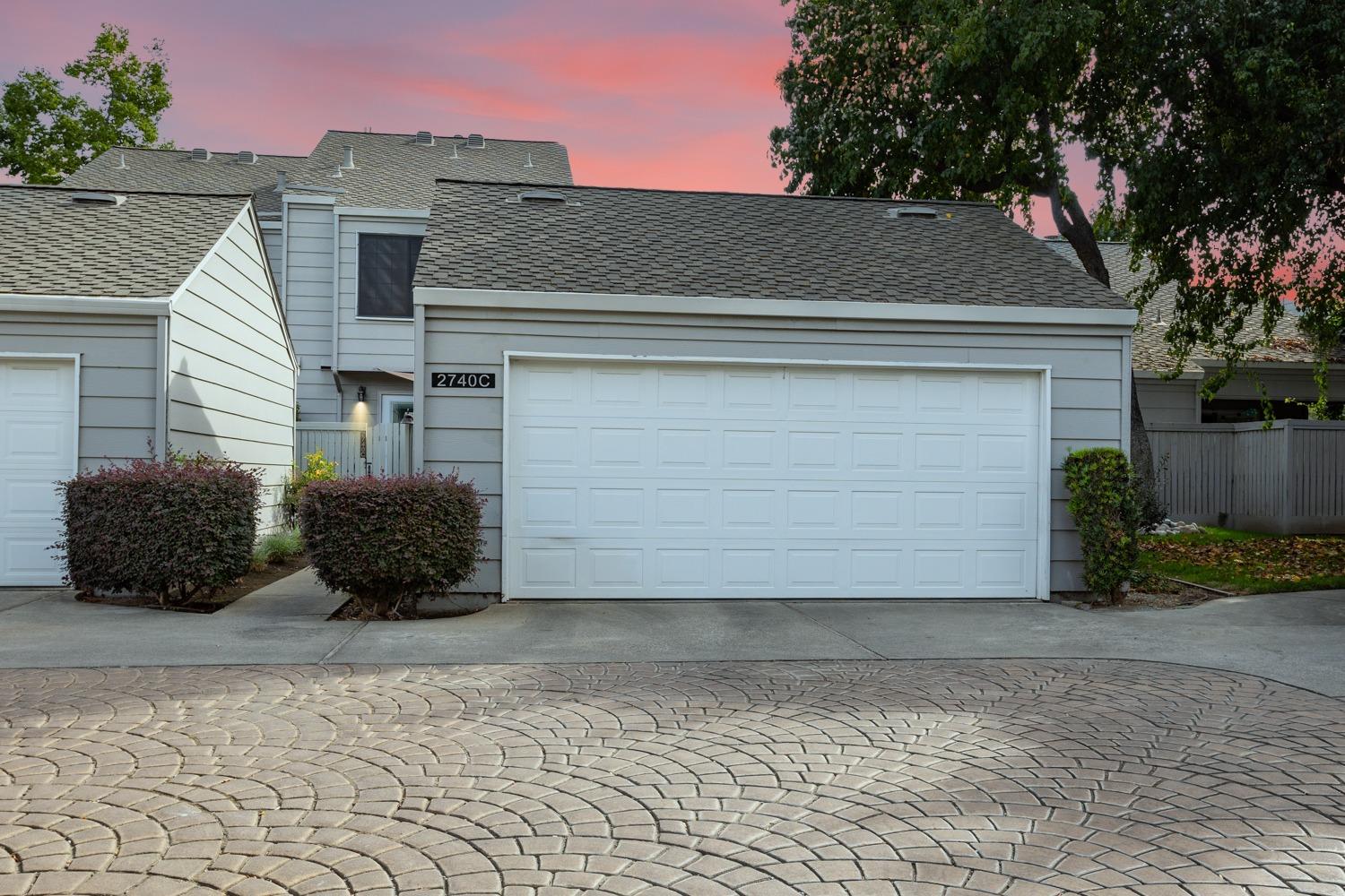 a view of backyard of house and car parked