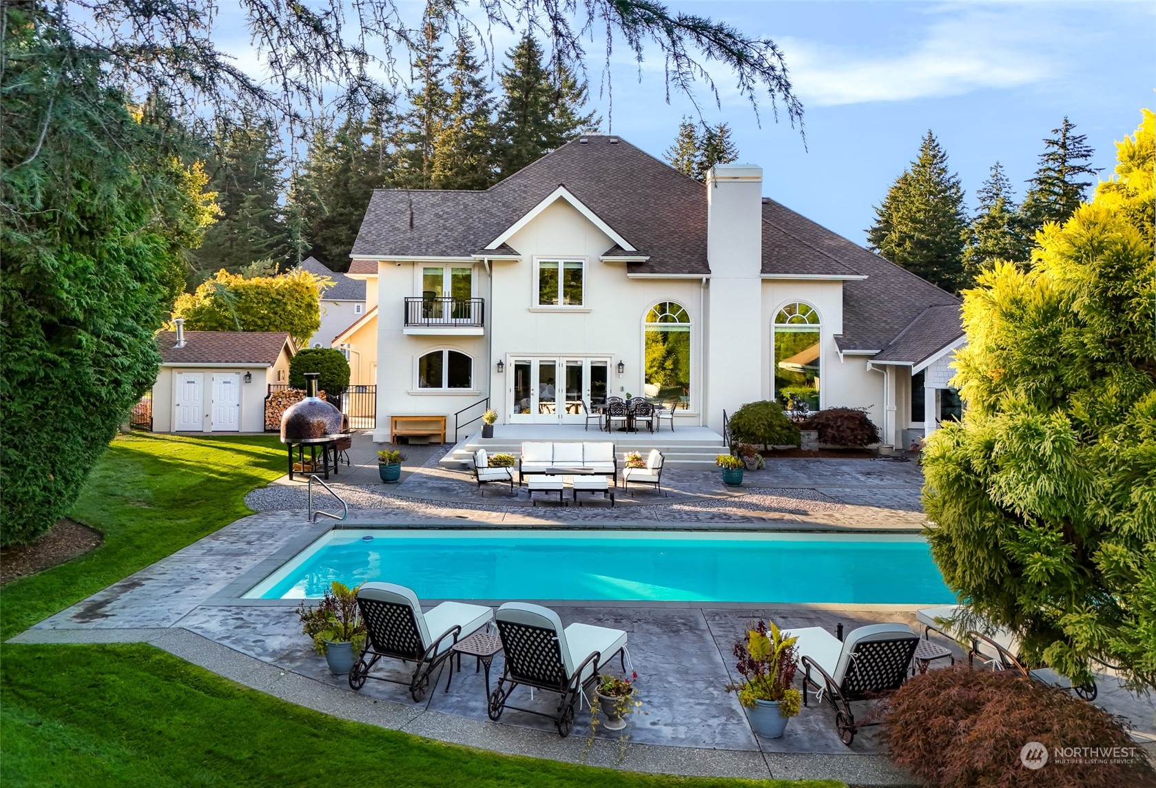 a aerial view of a house with swimming pool garden and patio