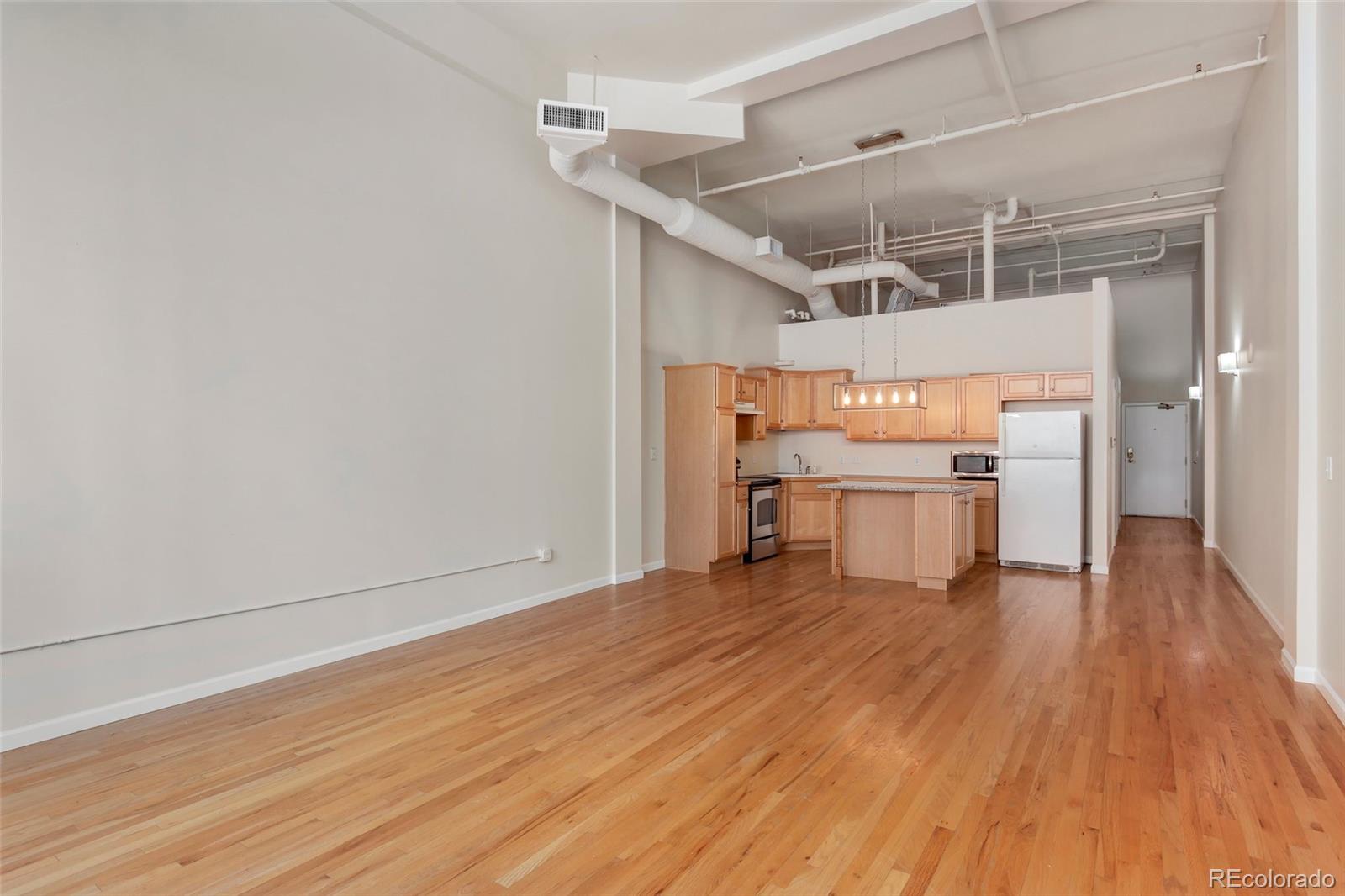 a view of a kitchen with wooden floor