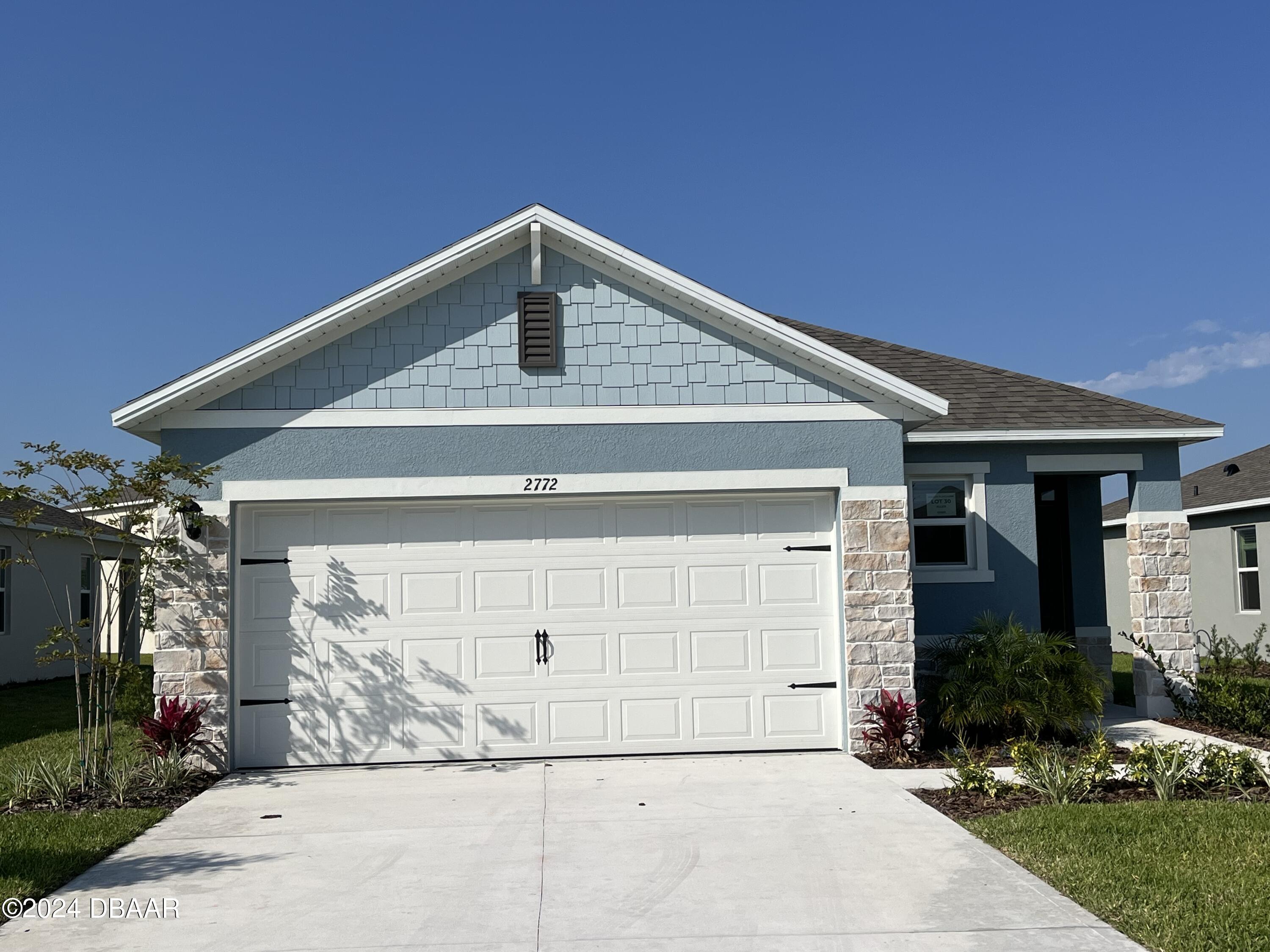 a front view of a house with garage