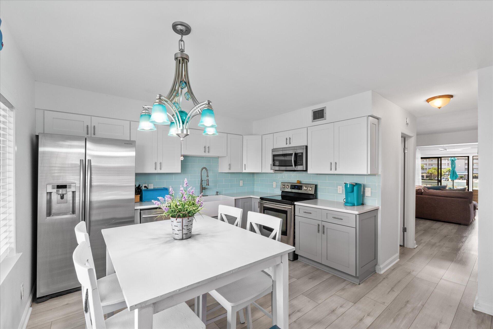 a kitchen with refrigerator cabinets dining table and chairs