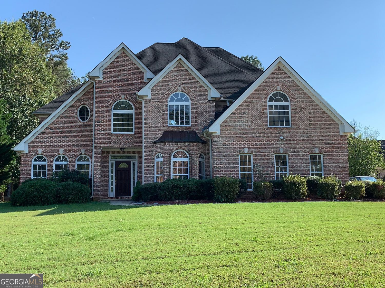 a front view of a house with garden