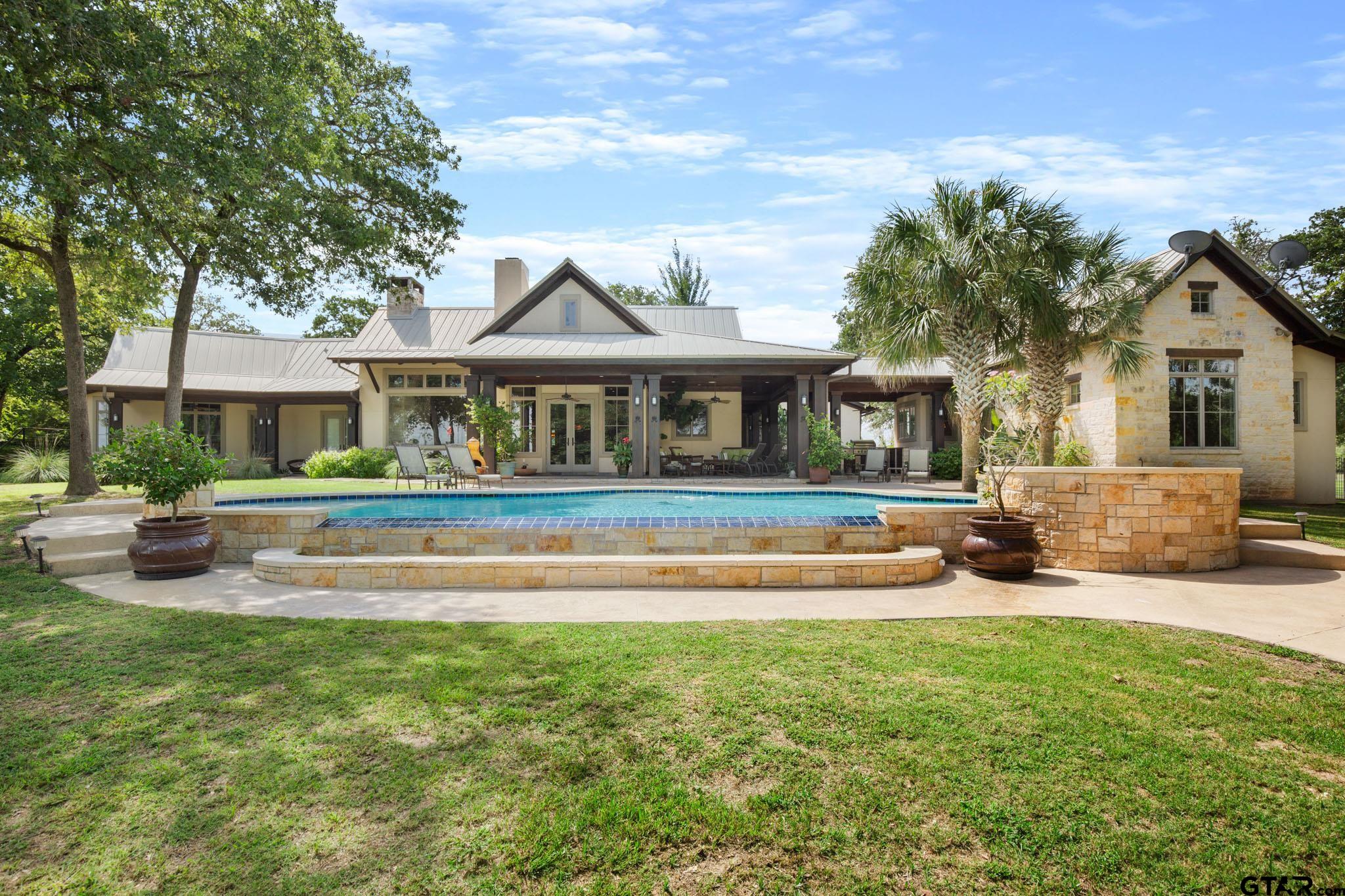 a view of house with yard and outdoor seating