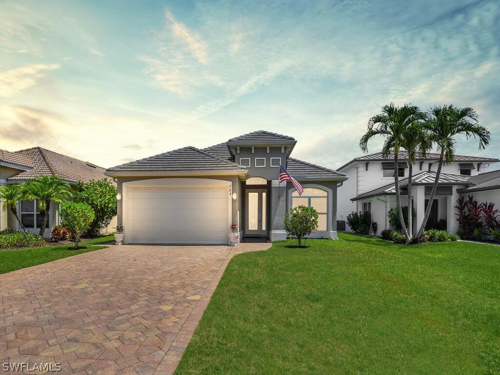 a front view of a house with a yard and garage