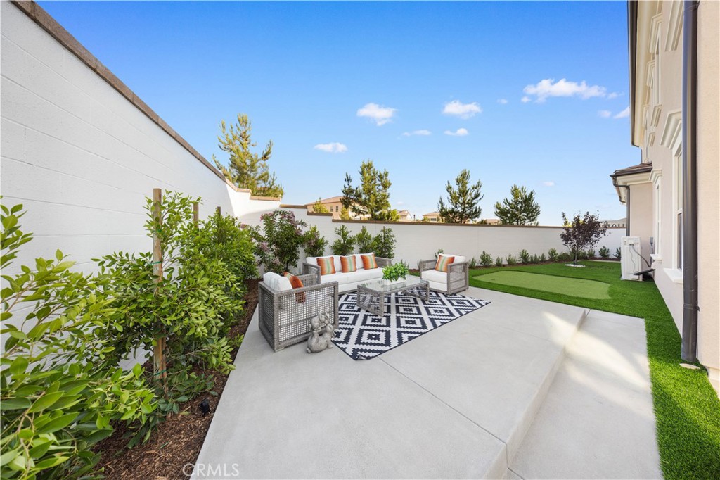 a view of a patio with a table and chairs