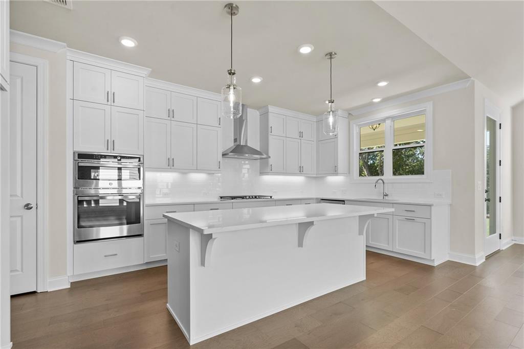 a kitchen with kitchen island granite countertop appliances and cabinets