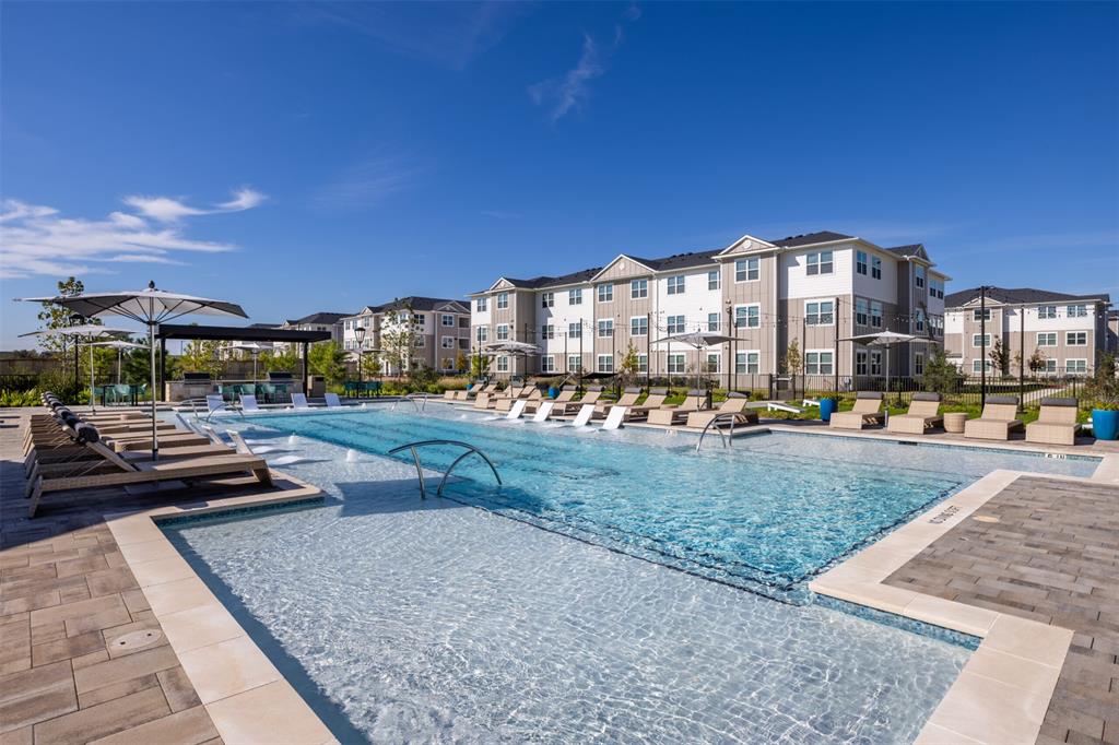 a view of a swimming pool with a patio and a yard