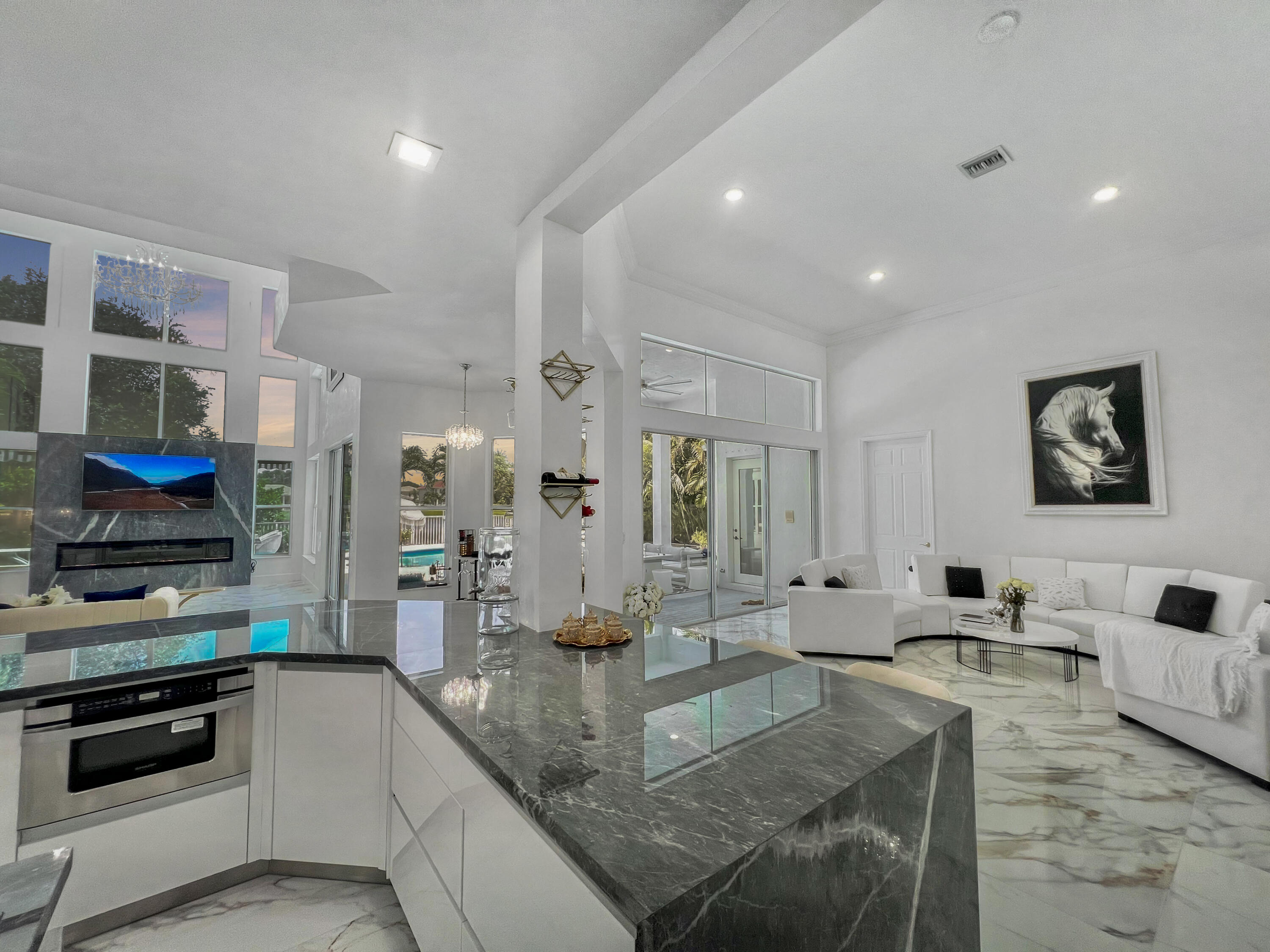 a large kitchen with stainless steel appliances granite countertop a stove and a sink