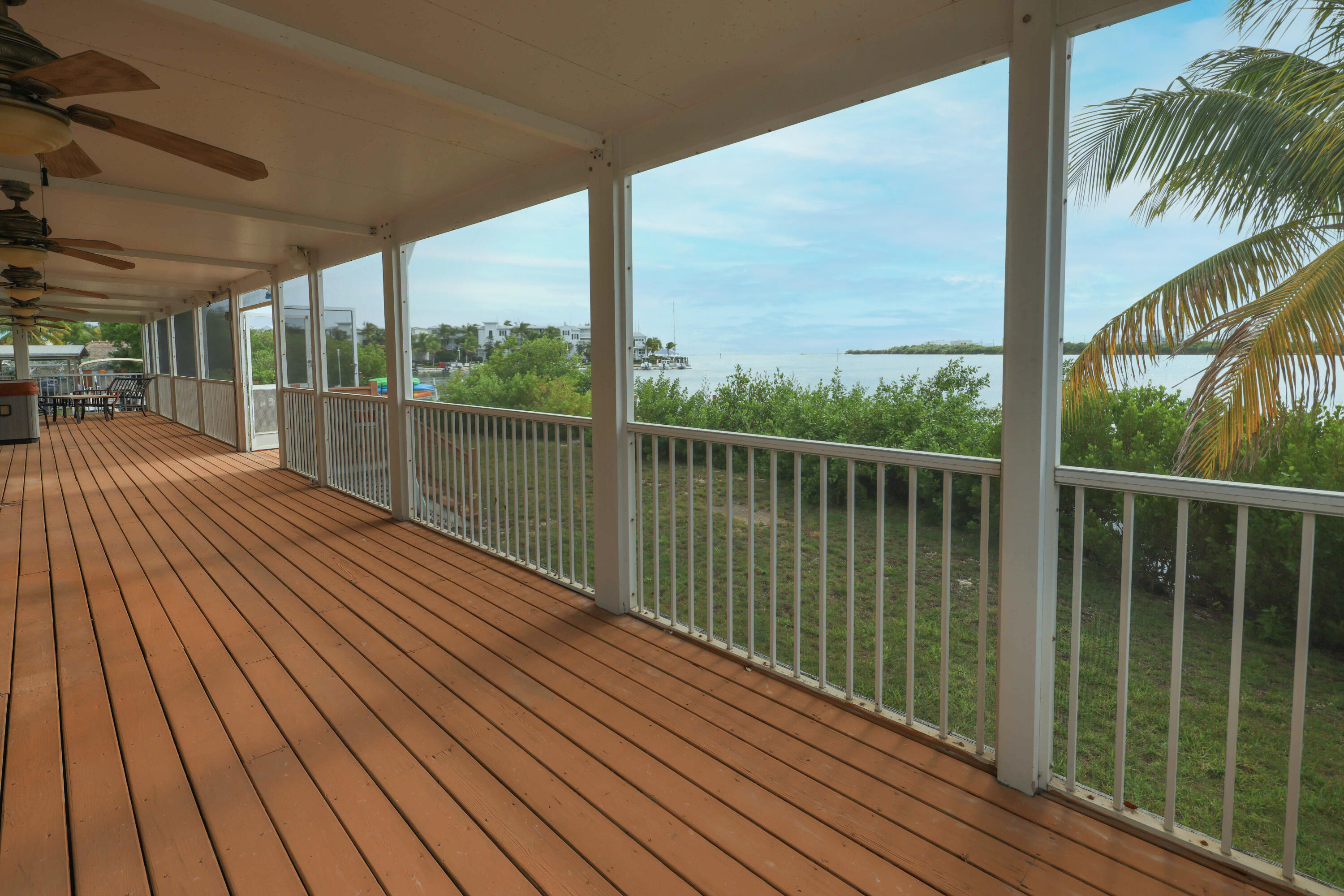 a view of a balcony with floor to ceiling windows with wooden floor