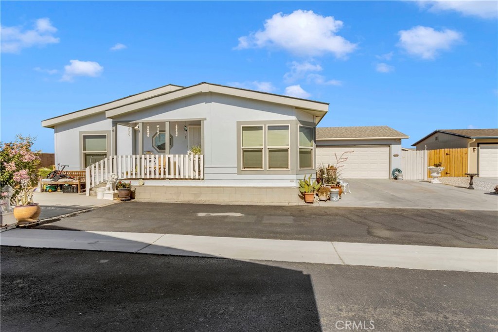 a front view of a house with a road