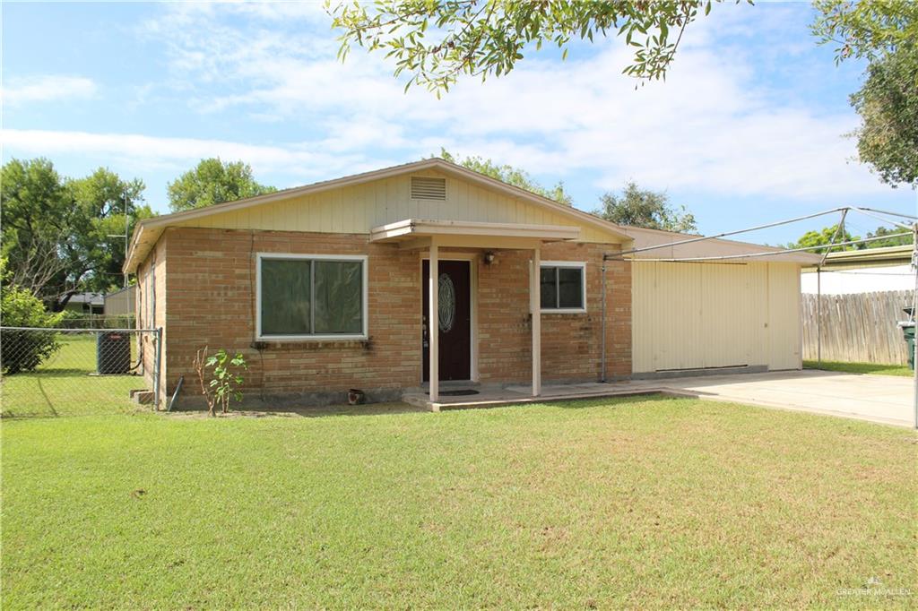 a front view of a house with yard and garage