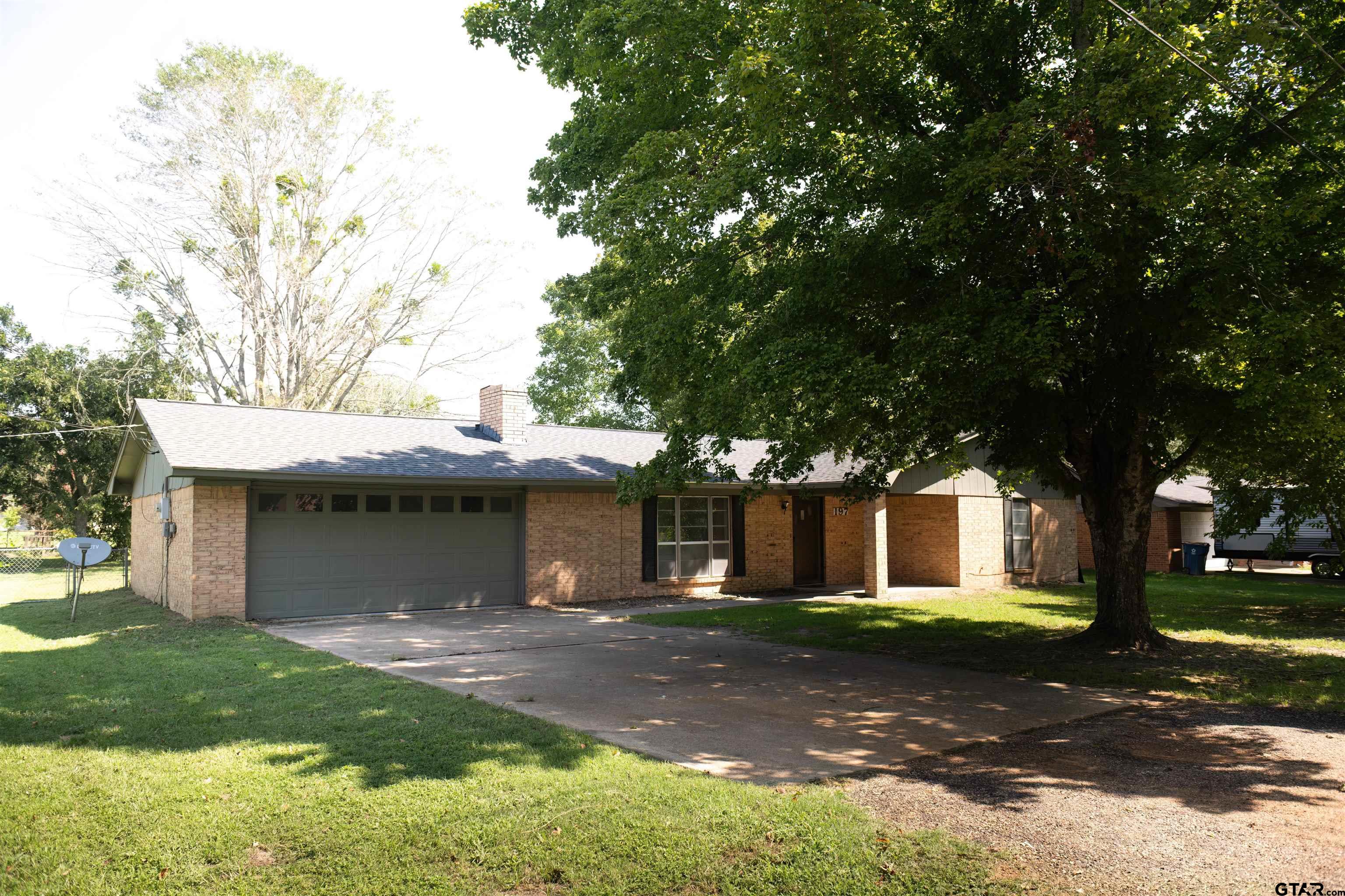 a view of house with a yard