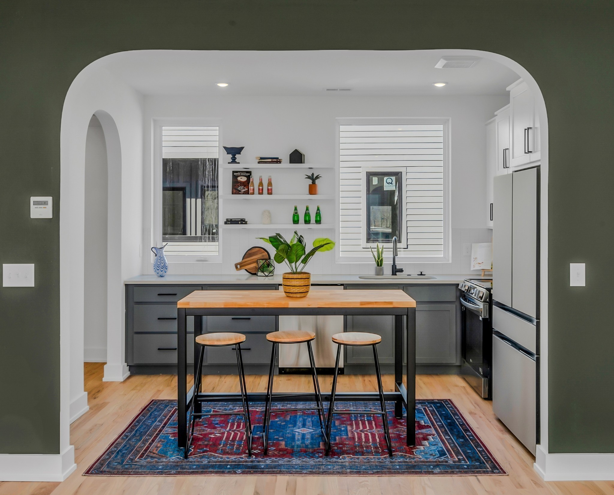 a living room with furniture a rug and a table