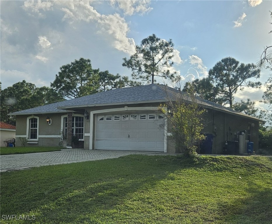 a front view of house with yard and green space