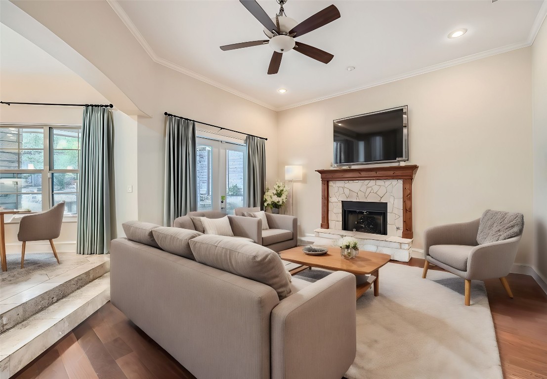 a living room with furniture a fireplace and a flat screen tv