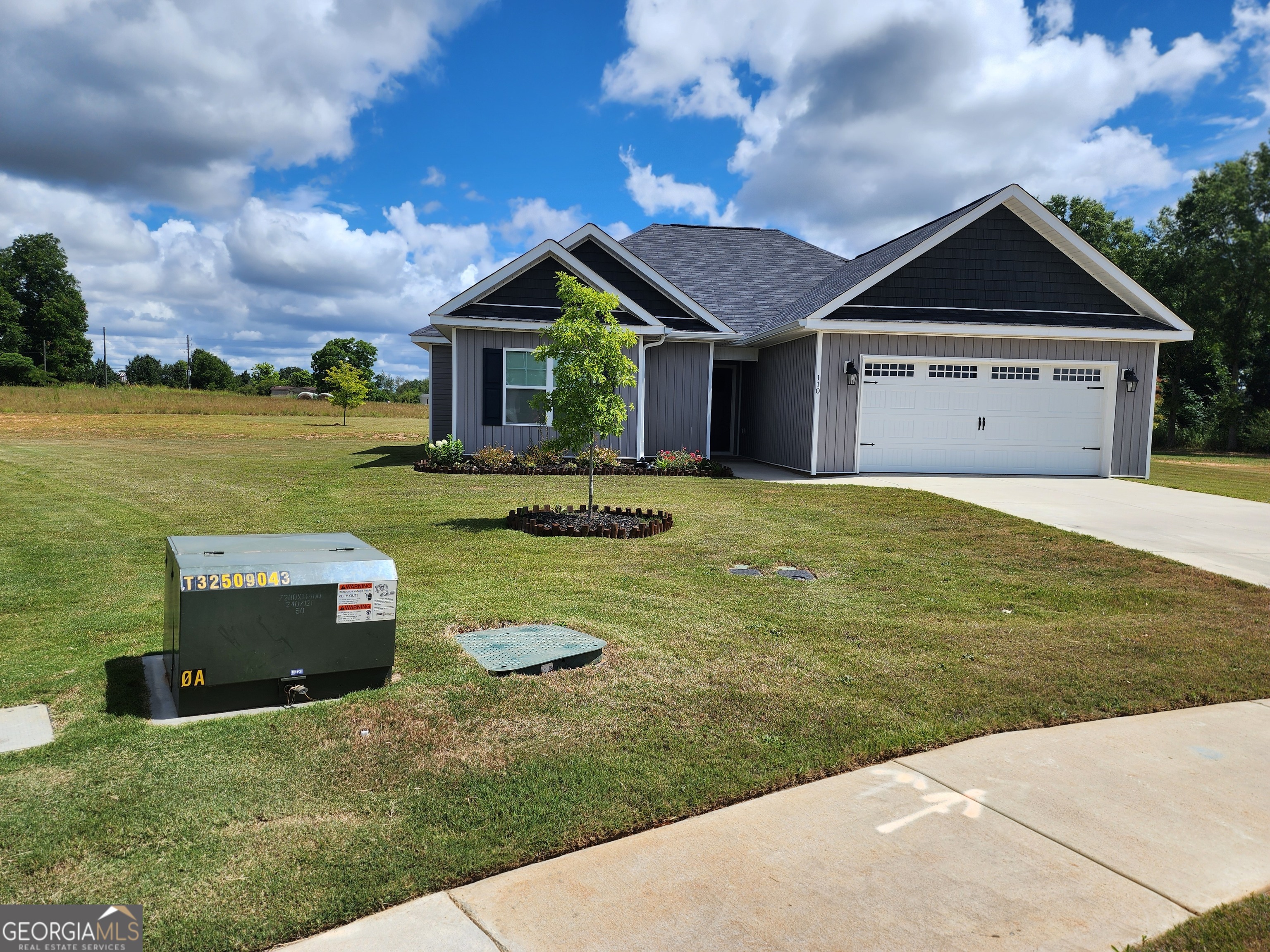 a front view of house with yard and car parked