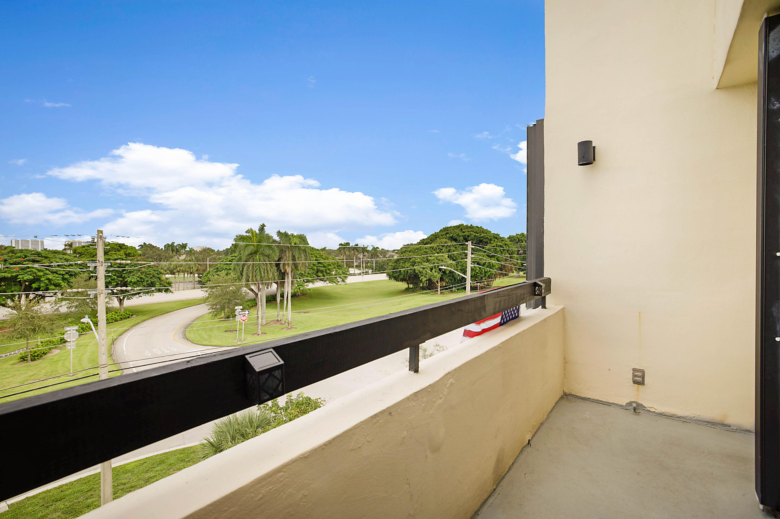 a view of balcony with floor to ceiling windows yard