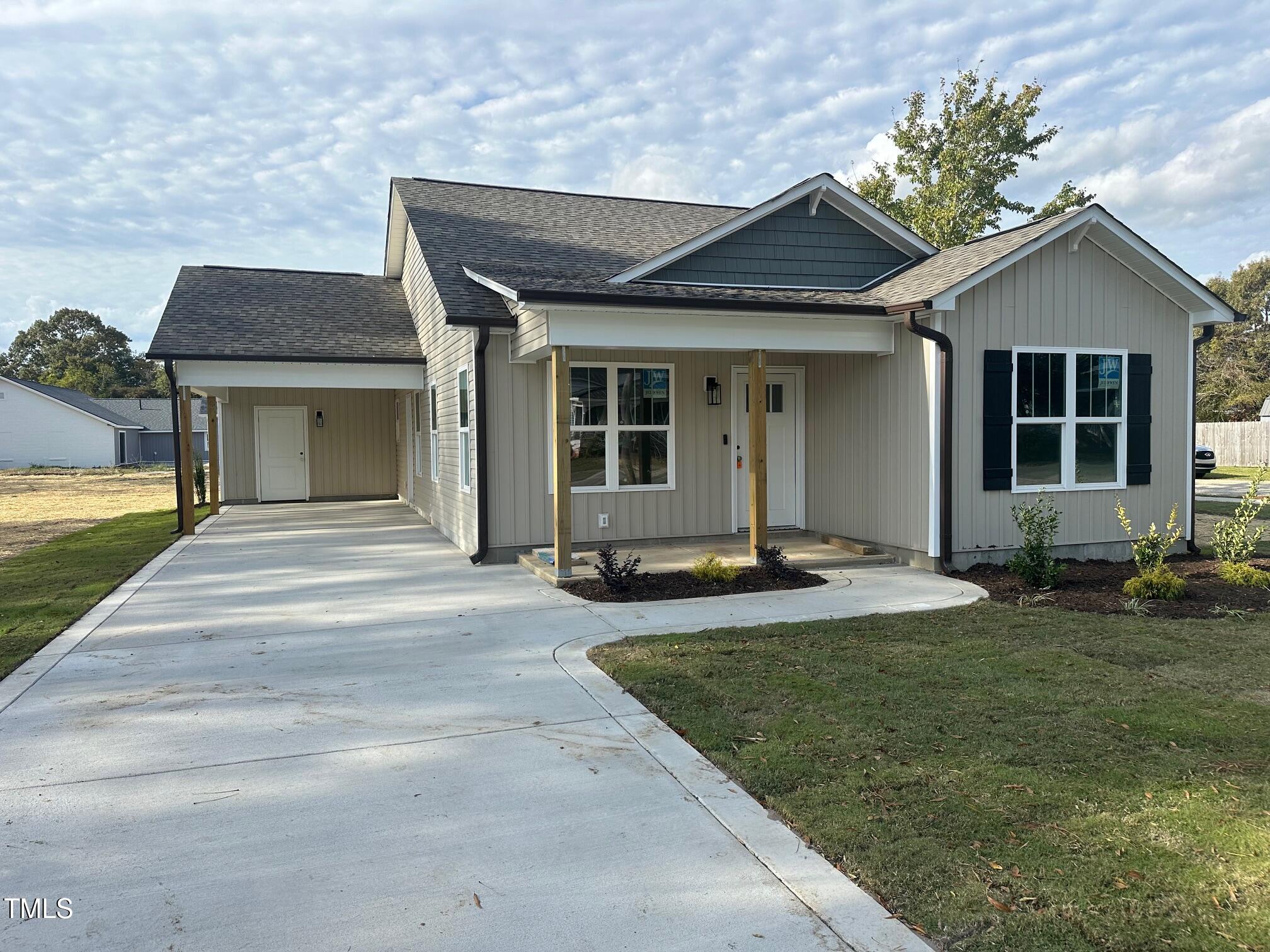 a front view of a house with yard and porch