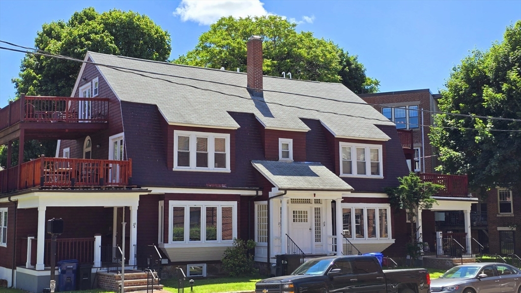 a front view of a residential apartment building with a yard