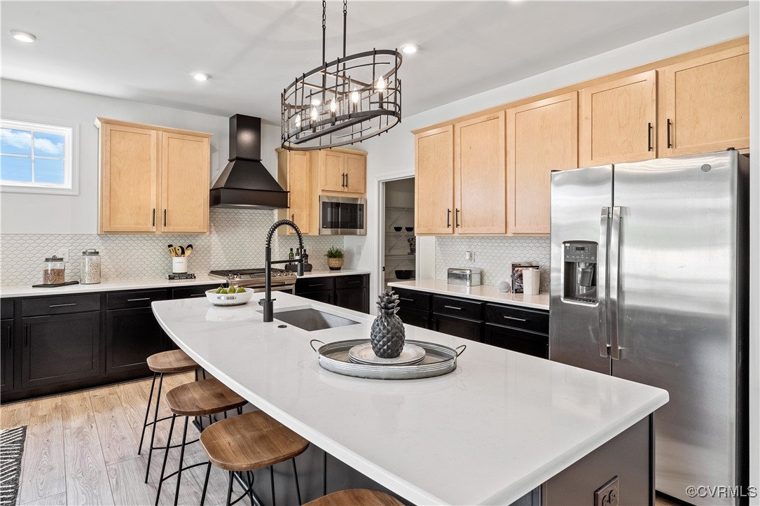 a kitchen with stainless steel appliances a dining table and chairs