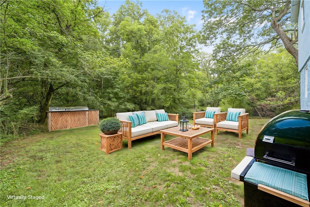 a backyard of a house with table and chairs