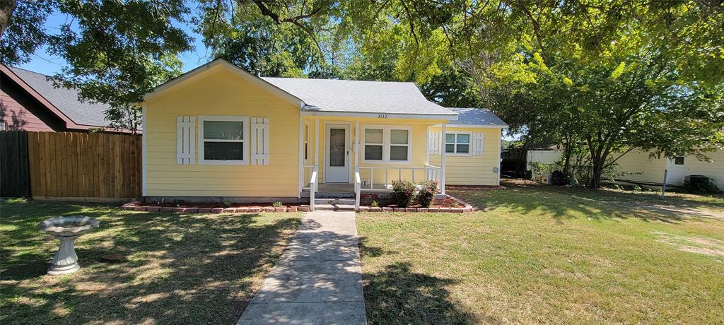 a front view of a house with yard