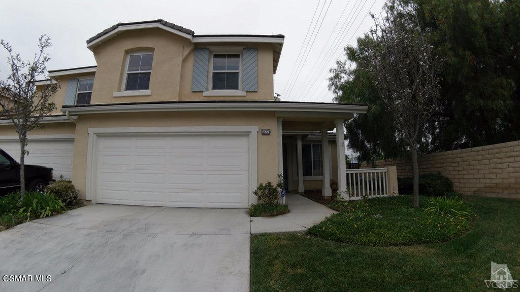 a view of a house with a yard and garage