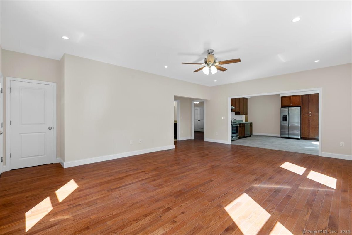 a view of livingroom with hardwood floor and a ceiling fan