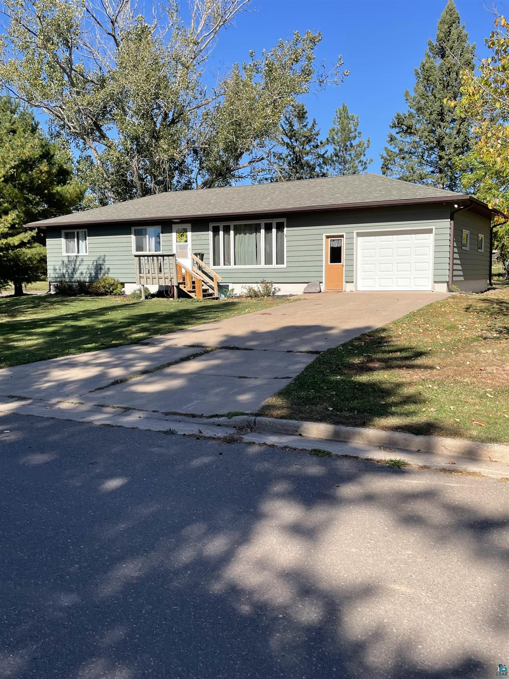 Ranch-style home with a garage and a front yard