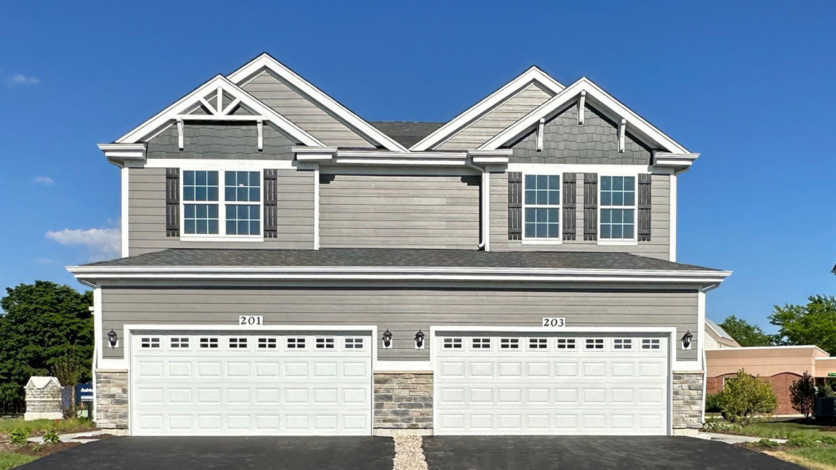 a view of a big house with wooden fence