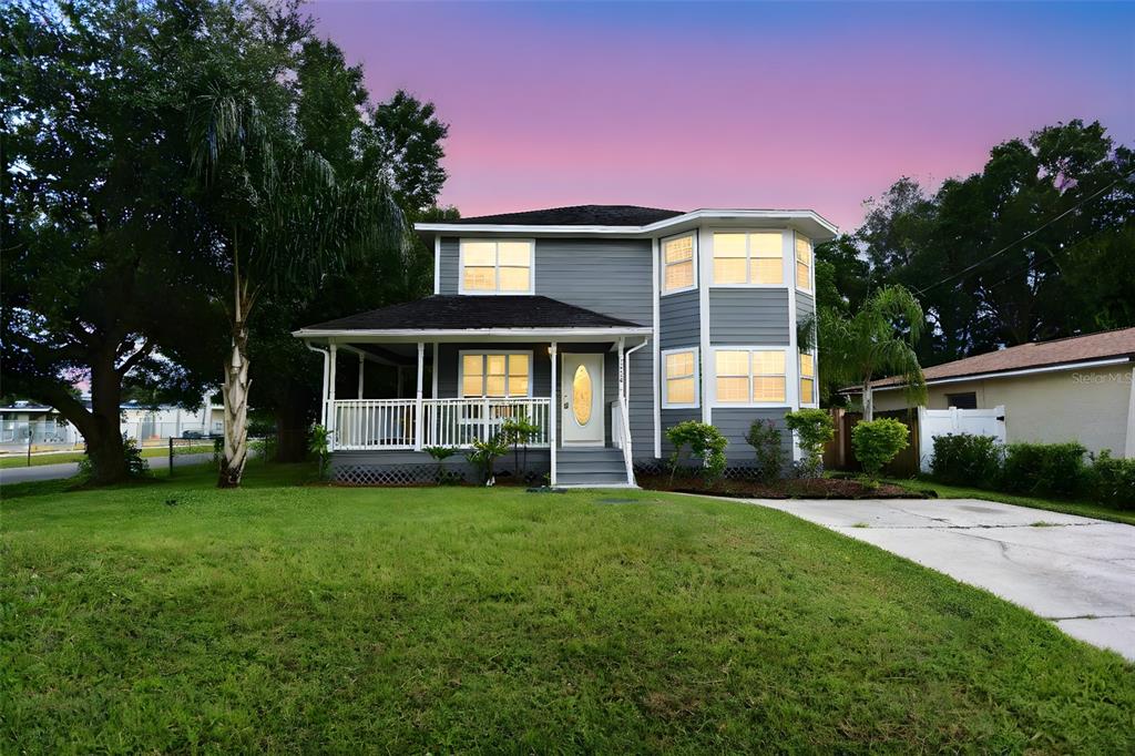 a front view of a house with a garden and yard