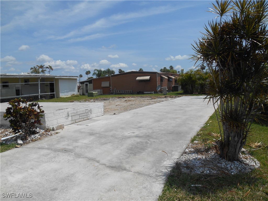 a pathway of a house with a yard