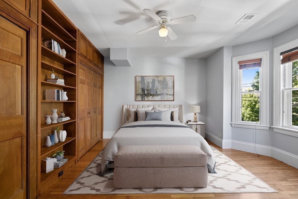 a bedroom with a large bed and a chandelier