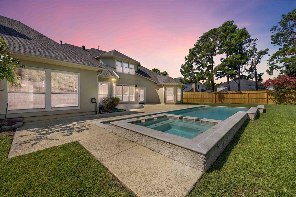 a view of a house with backyard and sitting area