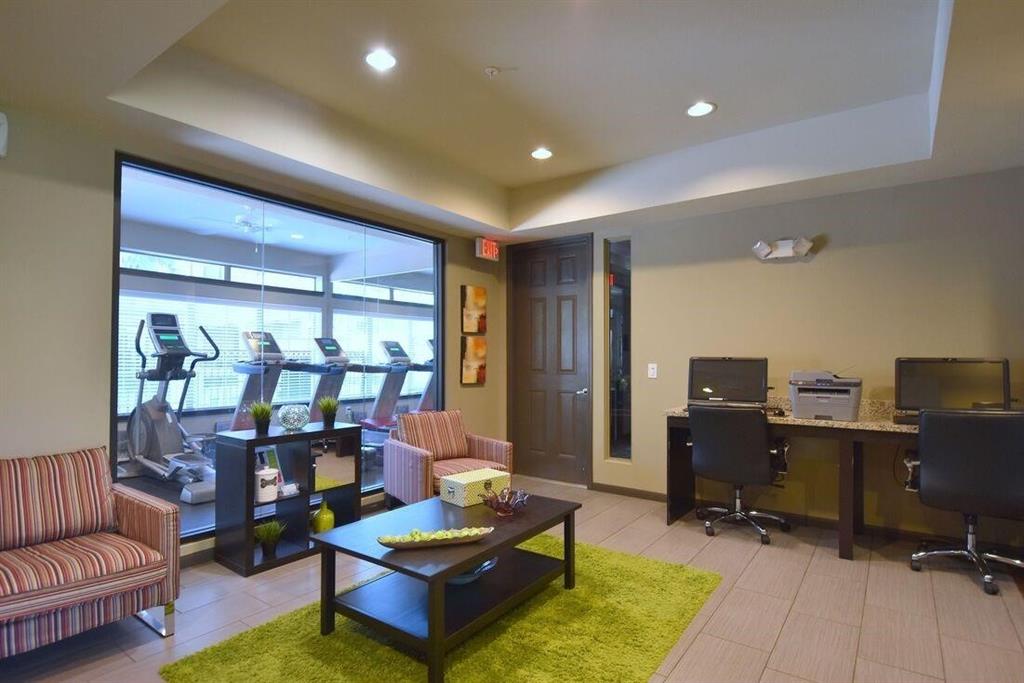 a living room with furniture a rug and a large window