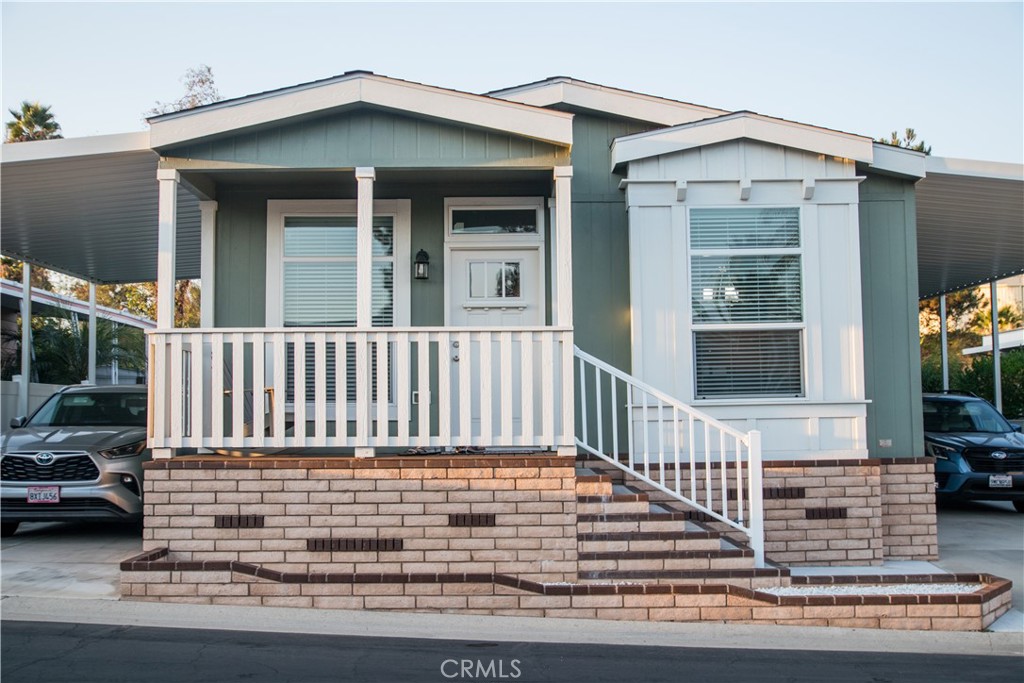 a view of a house with a small deck