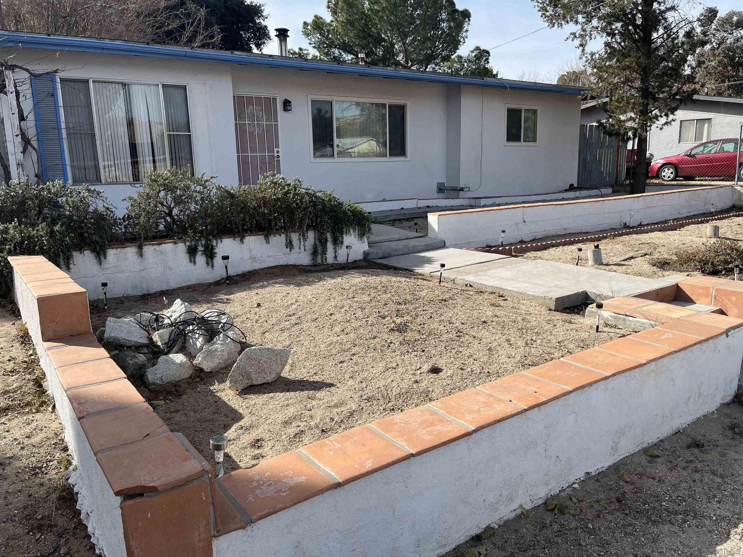 a view of a backyard with sitting area