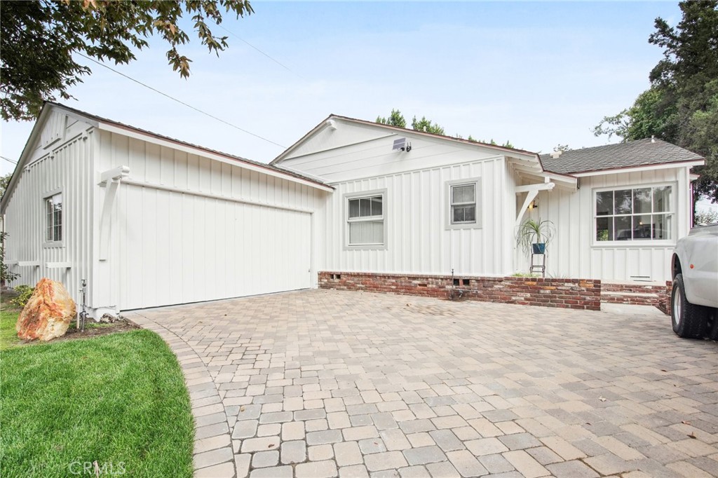 a view of a house with a yard and garage