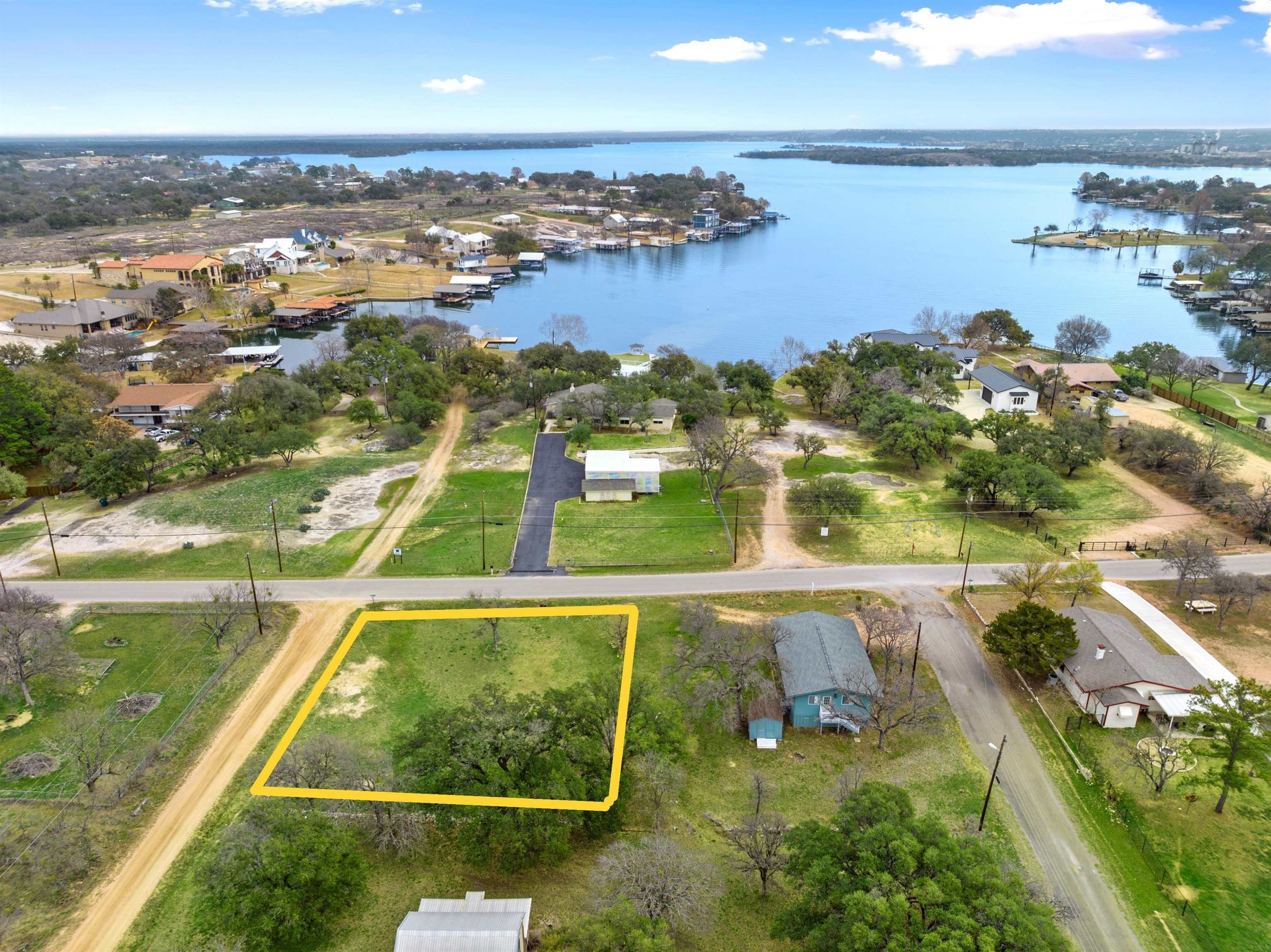 an aerial view of residential houses with outdoor space and river