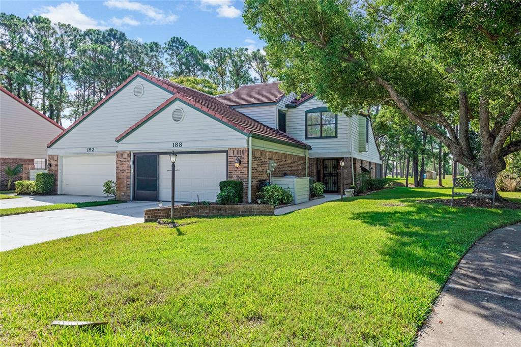 a view of a house with a yard and tree s